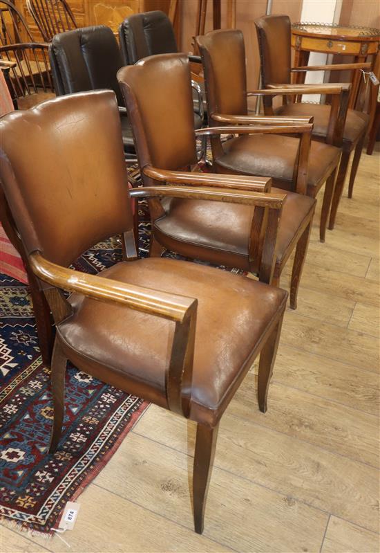 A set of four mid century beech elbow chairs